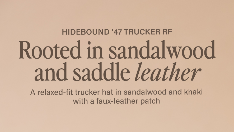 Hidebound '47 TRUCKER RF. Rooted in sandalwood and saddle leather. A relaxed-fit trucker hat in sandalwood and khaki with a faux-leather patch.